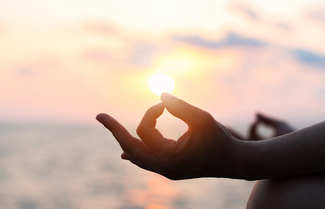 ムードラの指先に夕陽が乗っている