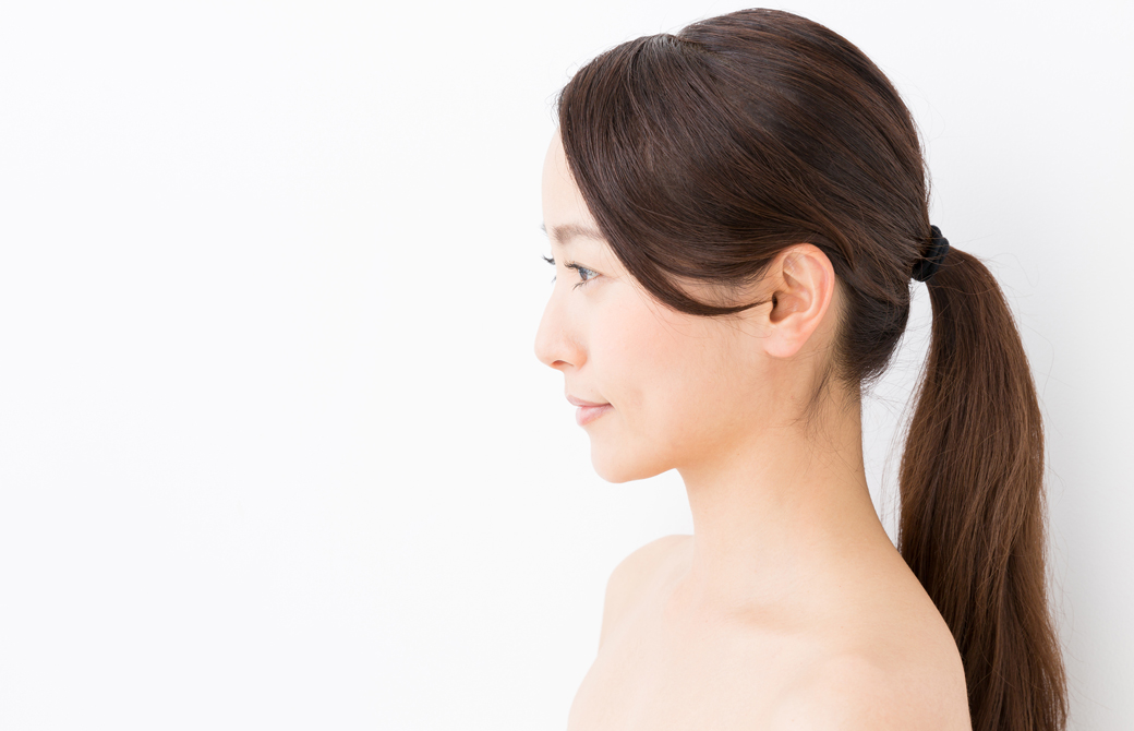 髪を後ろでひとつにまとめている女性の横顔