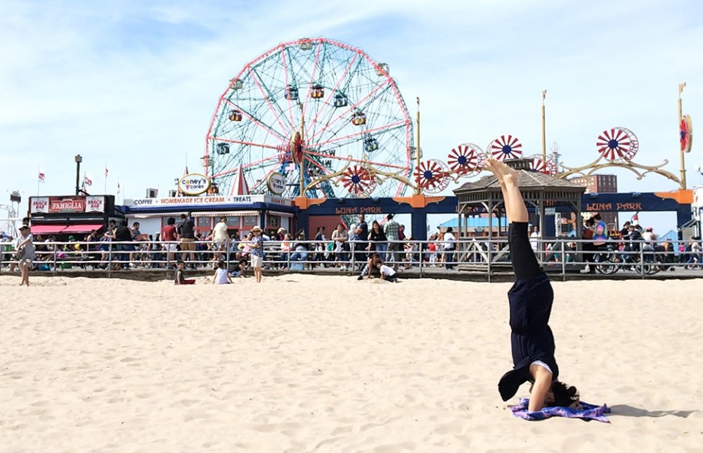 Mahokoがニューヨークのビーチでヘッドスタンドしている