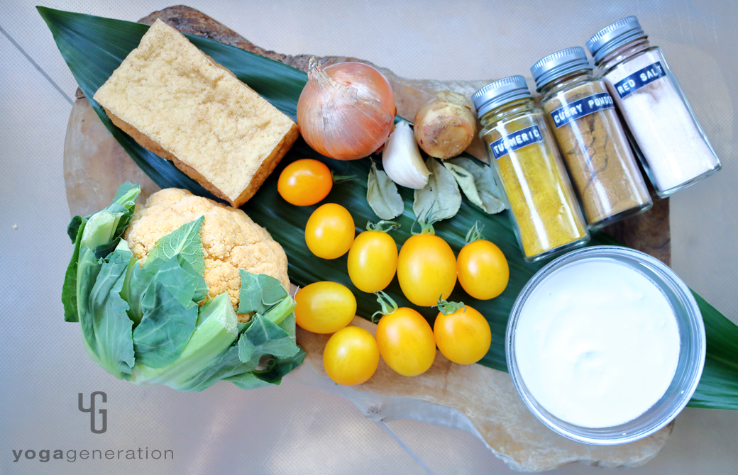 木製カットボードの上の厚揚げやカリフラワーなどの材料