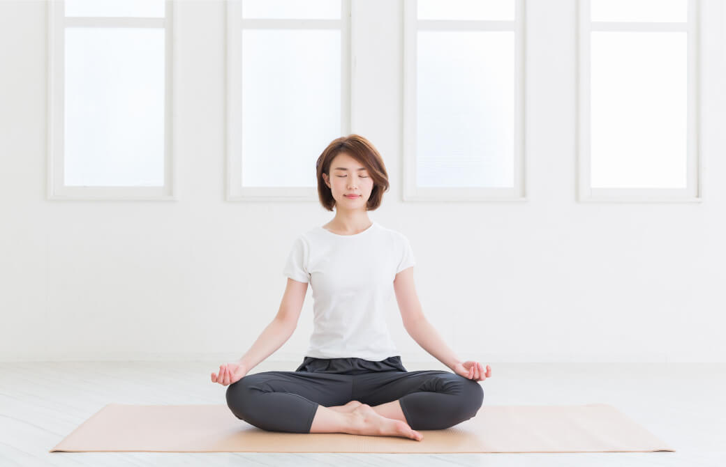 部屋で瞑想をする女性