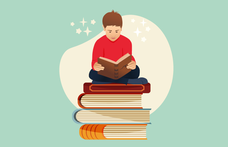 積み重なった本の上で読書する少年