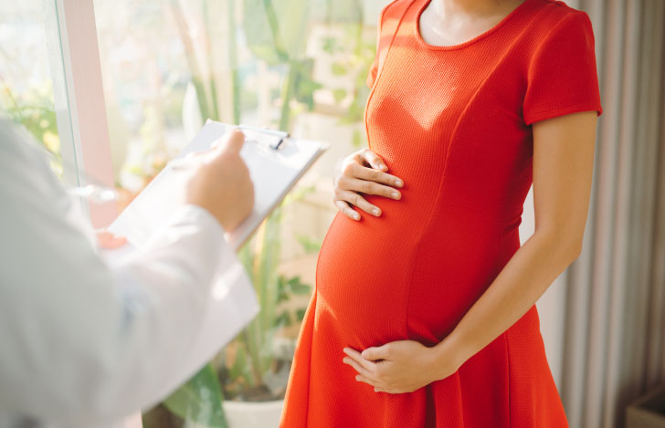 赤い服を着た妊婦と医師