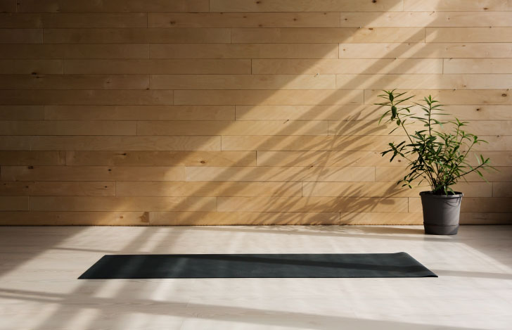 ヨガマットと植物が置かれた部屋