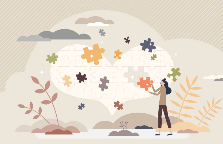 大きなハートのパズルを完成させようとしている女性