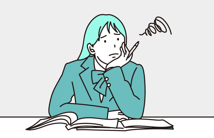 机に頬杖をついて思い悩む女子中学生