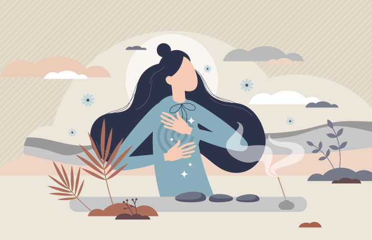 手を胸に当ててお香の香りに癒される女性