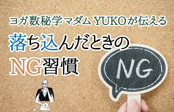 コルクボードと「NG」と書かれた小さなボードを持つ人の手